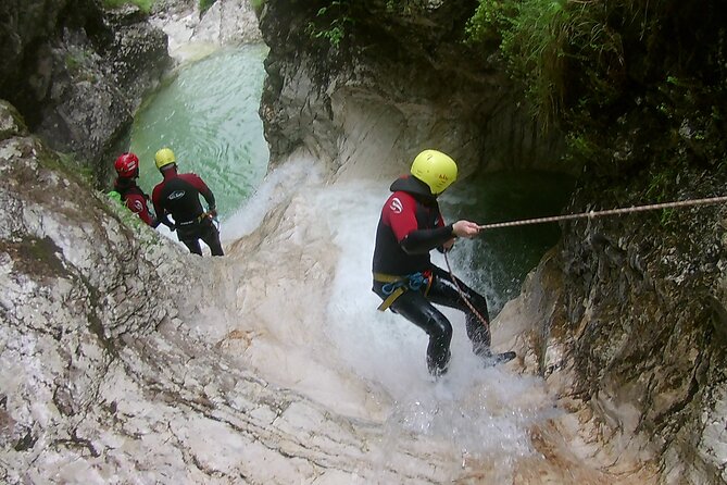 Canyoning In The Triglav National Park - The 50-meter rappel at Parabola waterfall