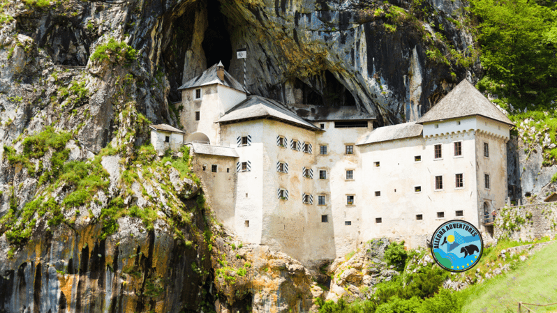 Zagreb: Postojna Cave, Predjama Castle & Ljubljana in a Day - Predjama Castle in a cliff
